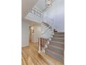 Elegant foyer features a staircase with white railings, light hardwood floors, and natural light at 540 Columbine Ave, Broomfield, CO 80020