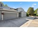 Exterior of the building with multiple garages and a well-kept facade on a sunny day at 2826 S Lansing Way, Aurora, CO 80014