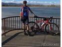 Pictured is a Personal with bike by the lake with mountains in the background at 10115 W 25Th Ave # 1, Lakewood, CO 80215