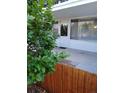 Welcoming entrance with white door, adjacent window, and a lush green shrub at 10115 W 25Th Ave # 1, Lakewood, CO 80215
