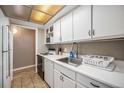 Well-lit kitchen boasts ample cabinet space and modern fixtures at 10115 W 25Th Ave # 1, Lakewood, CO 80215