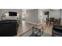 Open living room layout with modern furnishings and wood-style flooring at 10115 W 25Th Ave # 1, Lakewood, CO 80215