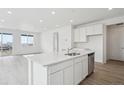 Modern kitchen featuring an island, stainless steel appliances, and lots of natural light at 6566 N Nepal St, Aurora, CO 80019