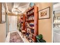 Hallway with tile flooring, a white door, and built-in wooden bookshelves at 7865 E Mississippi Ave # 304, Denver, CO 80247