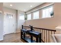 Inviting entryway with hardwood floors, console table, and decorative transom windows at 3367 New Haven Cir, Castle Rock, CO 80109