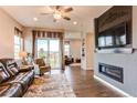 Cozy living room with a fireplace, plush seating, and sliding doors to outdoor area at 3367 New Haven Cir, Castle Rock, CO 80109