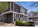 Charming two-story condo with gray siding, complemented by white trim and well-maintained landscaping at 6730 W 84Th Cir # 96, Arvada, CO 80003