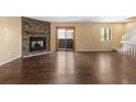 Spacious living room featuring a cozy fireplace, wood floors, and a sliding glass door to patio at 6730 W 84Th Cir # 96, Arvada, CO 80003