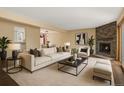 Bright living room with stylish fireplace and comfortable seating arrangement at 6730 W 84Th Cir # 96, Arvada, CO 80003