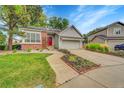 Charming single Gathering home with a well-manicured front yard and a red front door at 7975 S Gaylord Way, Centennial, CO 80122