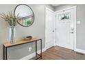 Inviting entryway with a stylish console table, modern mirror, and bright front door at 2714 S Raleigh St, Denver, CO 80236