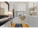 Elegant entryway leads to a spacious living room with a fireplace and neutral decor at 4932 Democrat Dr, Broomfield, CO 80023