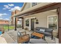 Inviting front porch featuring comfortable seating, a swing, and charming architectural details at 1832 W 33Rd Ave, Denver, CO 80211