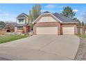 Charming two-story home with a three-car garage and large driveway providing ample parking space at 5603 S Pagosa Ct, Centennial, CO 80015