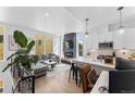 Bright, open-concept living space featuring a modern kitchen, a comfortable living room, and large windows at 1232 N Yates St # 3, Denver, CO 80204