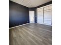 Cozy bedroom with large built in shelving and modern flooring at 9695 Nucla St, Commerce City, CO 80022