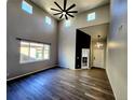 Open-concept living room featuring high ceilings, modern lighting, and sleek flooring at 9695 Nucla St, Commerce City, CO 80022