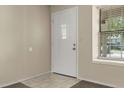 The entryway has neutral walls and tile floors near the front door and window at 18171 E Arizona Ave # B, Aurora, CO 80017