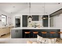 Modern kitchen with large island, dark cabinetry, and high-end appliances at 3120 Braun Ct, Golden, CO 80401