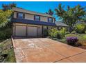 Two-story house with a beige facade, attached two-car garage, and landscaped yard at 1866 W Davies Ave, Littleton, CO 80120