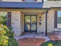 Inviting front entry with a double-door entry and brick facade at 1866 W Davies Ave, Littleton, CO 80120