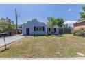 Charming light-blue home with tidy front yard, black shutters and a wheelbarrow at 3570 Center Ave, Denver, CO 80219