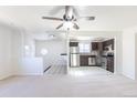 Bright, open living room and kitchen with neutral carpet and ceiling fan at 3570 Center Ave, Denver, CO 80219