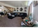 Spacious living room featuring a comfortable sectional sofa and stairs leading to upper level at 155 Paris Cir, Aurora, CO 80011