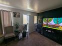 Cozy living area with neutral tones, bright light, and a view of the home's entrance at 155 Paris Cir, Aurora, CO 80011