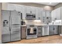 Modern kitchen featuring stainless steel appliances, granite countertops, and a stylish backsplash at 3219 W 19Th Ave # 3, Denver, CO 80204