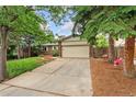 View of the front yard showing driveway and a front-facing two-car garage at 15104 E Utah Pl, Aurora, CO 80012