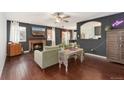 Cozy living room with a fireplace, hardwood floors, and a comfortable green sofa at 15104 E Utah Pl, Aurora, CO 80012