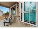 Inviting front porch featuring comfortable seating and a stylish screen door at 2805 Masters Ln, Castle Rock, CO 80104
