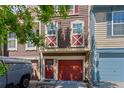 Charming townhome featuring a bright red garage door and unique exterior details at 12043 E Ford Cir, Aurora, CO 80012