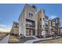 Modern three-story townhome with attached two-car garage and balcony at 15878 E Broncos Pl, Englewood, CO 80112