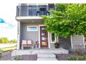 Inviting entryway with cozy seating and manicured landscaping that leads to a front door at 15878 E Broncos Pl, Englewood, CO 80112