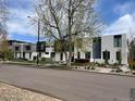Contemporary townhomes with black and white exteriors line a tree-lined street with well-maintained landscaping at 3953 Vrain St, Denver, CO 80212