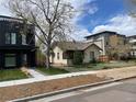 A house with a sidewalk leading to it, surrounded by a lawn and other houses in the background at 3953 Vrain St, Denver, CO 80212