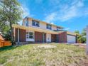 Charming two-story home featuring a brick facade, two-car garage, and a well-maintained front yard at 8694 E Eastman Ave, Denver, CO 80231