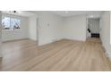 Open living room featuring hardwood floors, recessed lighting and staircase access to the second floor at 8694 E Eastman Ave, Denver, CO 80231