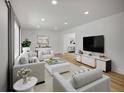 Bright living room featuring neutral furniture, a large window, and recessed lighting at 8694 E Eastman Ave, Denver, CO 80231
