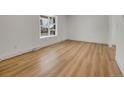 Bright living room featuring hardwood floors, recessed lighting and a large window providing natural light at 8694 E Eastman Ave, Denver, CO 80231