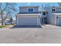 Two-story house with large garage and an asphalt driveway at 12561 E Cornell Cir, Aurora, CO 80014