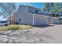 Two-story house showing grass, driveway, and other units at 12561 E Cornell Cir, Aurora, CO 80014