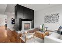 Living room with a large modern fireplace and hardwood floors at 1804 Little Raven St, Denver, CO 80202