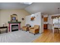 Cozy living room featuring a fireplace, vaulted ceilings, and stylish decor at 2195 S Espana St, Aurora, CO 80013