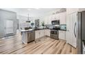 Bright kitchen with white cabinets, stainless steel appliances, a stylish brick backsplash and breakfast nook at 1481 Red Poppy Way, Brighton, CO 80601