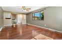 Cozy living room with hardwood floors, ceiling fan, and ample lighting at 12408 E Ohio Ave, Aurora, CO 80012