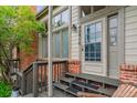 Charming home entrance with a brick facade, wooden steps, and a welcoming front door at 4231 S Fairplay Cir # E, Aurora, CO 80014