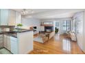 Virtually staged kitchen and living area with hardwood floors at 4862 E Kentucky Ave # D, Denver, CO 80246